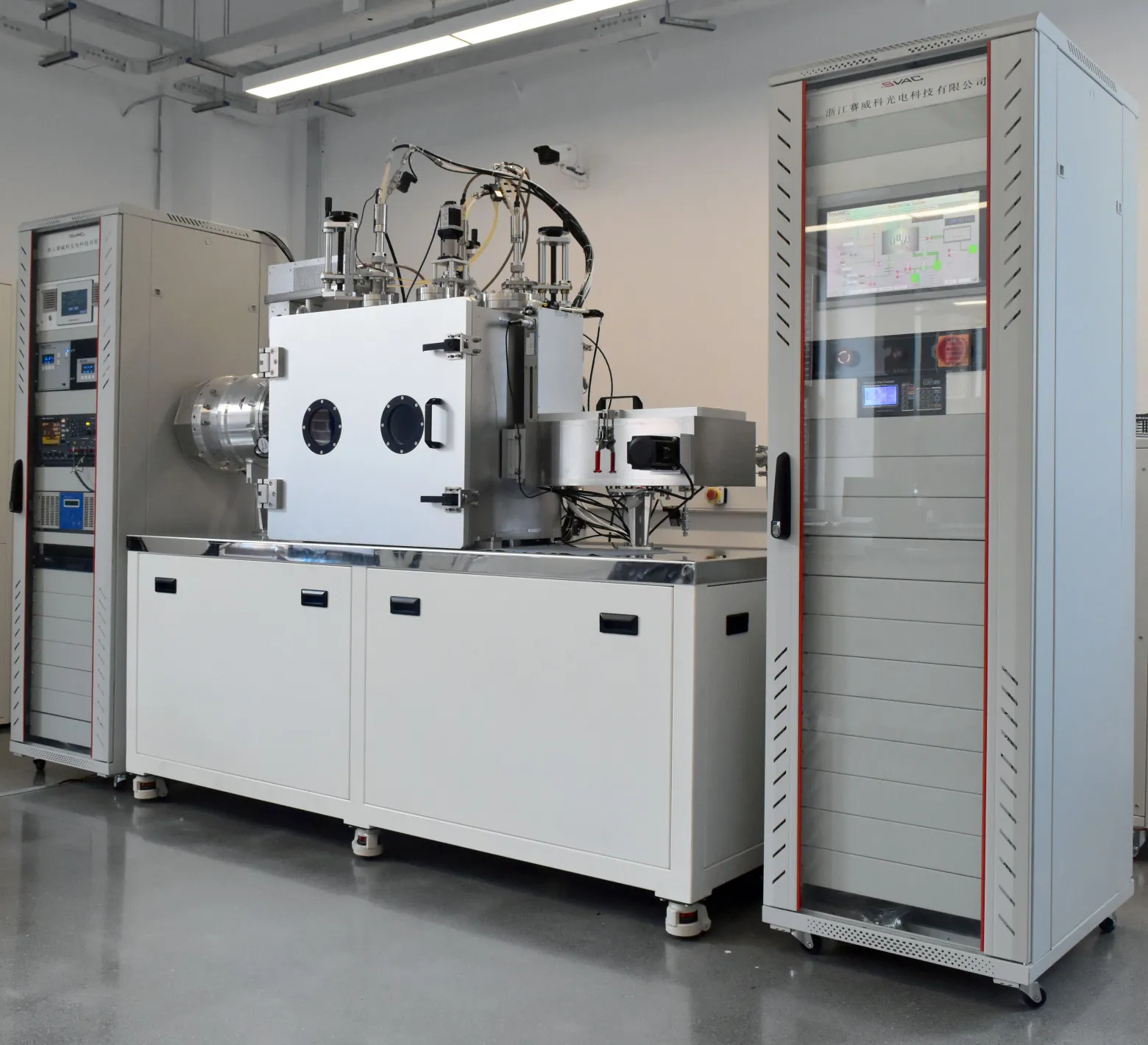 The China chamber: four magnetrons, ion etch source, airlock, water-cooled substrate holder